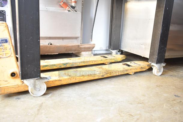 Sveba Dahlen Gemini Mini Rotating Rack Oven on commercial casters, partly visible, used condition, with pallet truck.