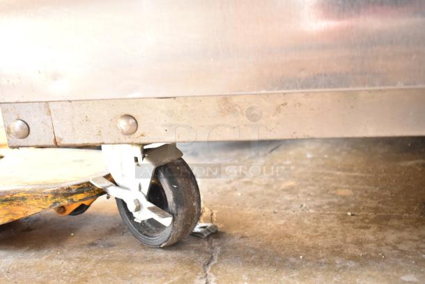 Delfield 6151XL-S freezer caster, partially rusty, showing metal frame. Commercial 2-door freezer detail.