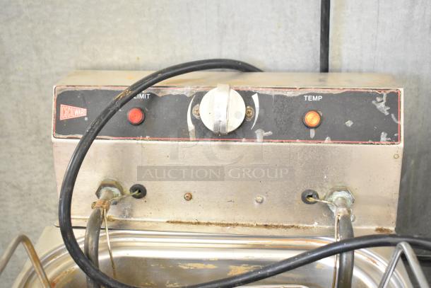 Cecilware countertop electric fryer with dual metal fry baskets. Features 115 volts, 1 phase. Control panel shows wear.