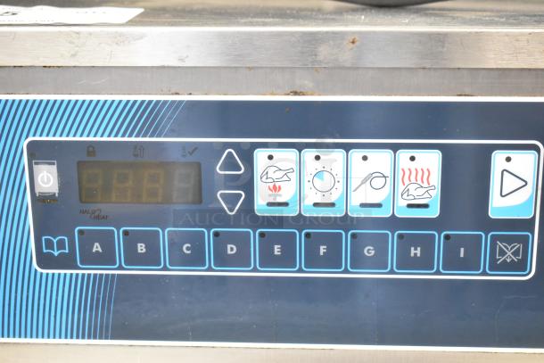 Alto Shaam heated holding cabinet control panel with digital display and function buttons, mounted on commercial casters.