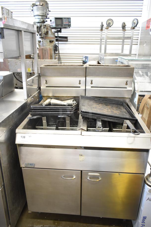 Pitco Frialator commercial gas fryer with dual baskets, stainless steel body, used condition. Model tag visible.