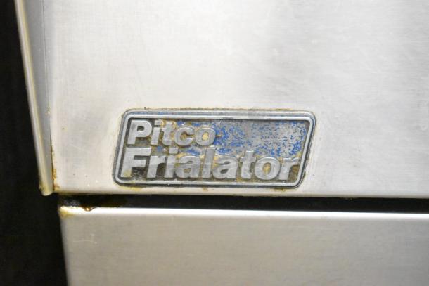 Pitco Frialator commercial gas fryer with visible brand label, showing signs of wear.