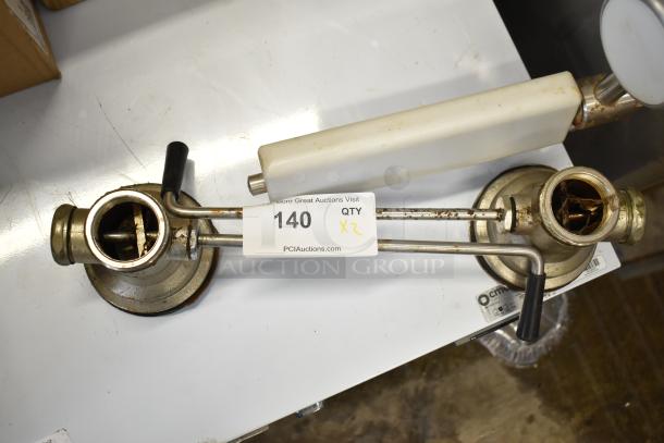 Two metal sink drains with attached levers, slightly rusted. Label shows "140, QTY x2, PCIAuctions.com."
