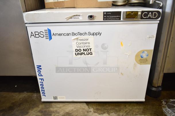 American BioTech Supply chest freezer, white, labeled for vaccines, “DO NOT UNPLUG.” Visible wear, includes digital controls.