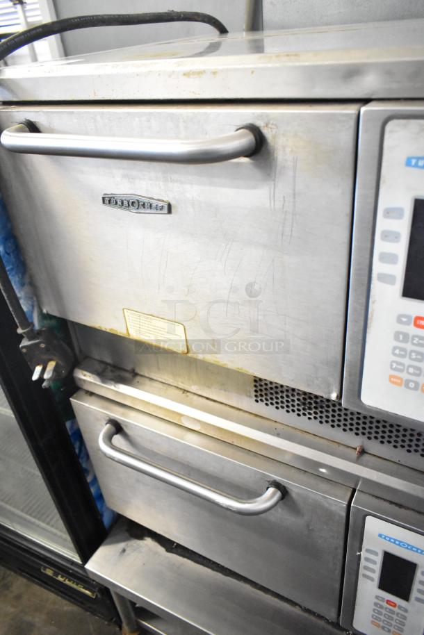2 Turbochef NGC rapid cook ovens on a commercial stand. Electric powered, 208/240V, 1 phase. Some surface wear visible.