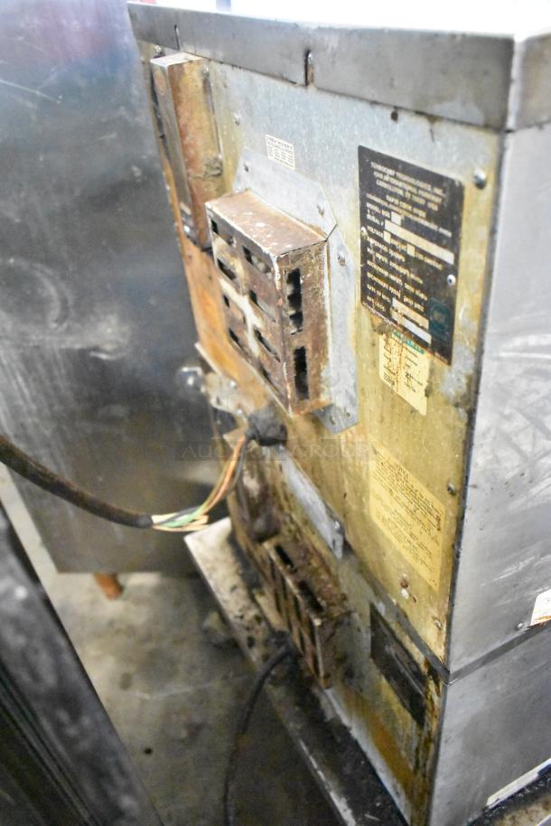 Two Turbochef NGC commercial electric rapid cook ovens on a stand, visible wear, voltage labels, metal finish.