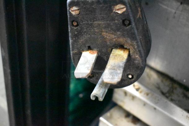 Close-up of a worn plug from a Turbochef NGC Commercial Rapid Cook Oven, showing visible tarnish.