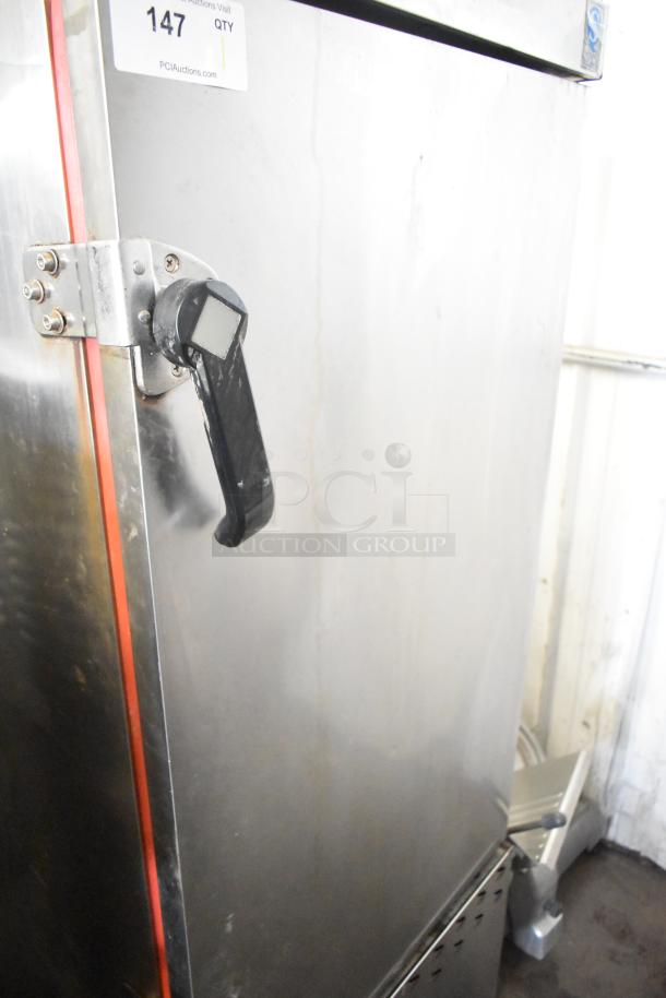 Commercial smoking cabinet with a metal finish, sturdy handle, and visible auction tag reading "147 QTY." Appears in used condition.