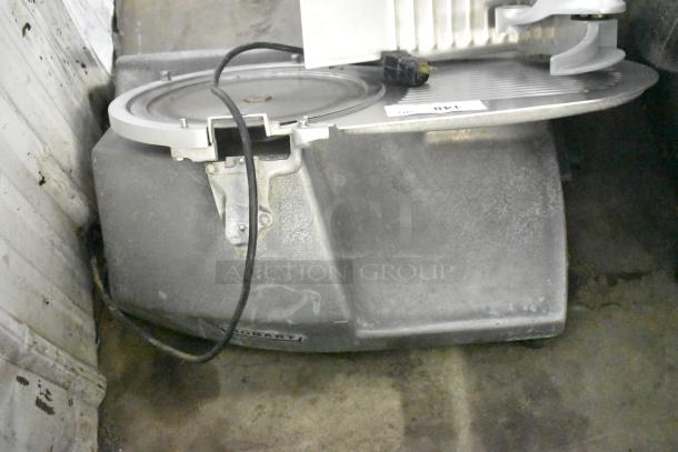 Hobart commercial countertop meat slicer, 115 volts, 1 phase. Visible wear, Hobart branding, power cord attached.