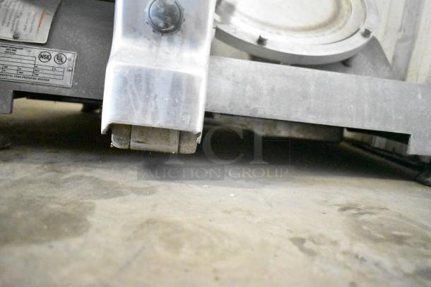 Hobart commercial countertop meat slicer, 115V, 1 phase, features durable metal construction, visible markings on the base.