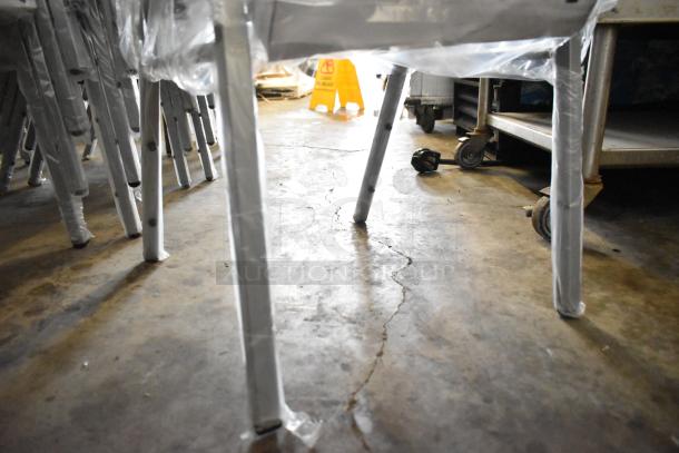 120 Scratch and Dent Flash Furniture HERCULES Crown Back Chairs, blue fabric, silver frame, new. Visible legs wrapped in plastic.