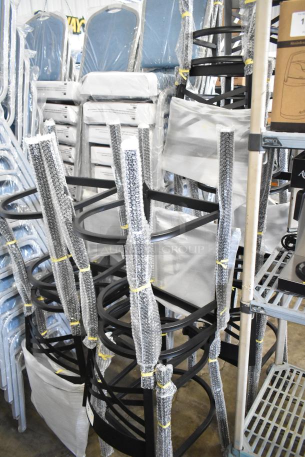 8 new Lancaster Table & Seating black bar height chair frames, scratch and dent condition, no cushions, wrapped in bubble wrap.