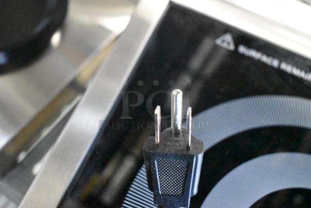 Brand new Avantco 177IC1800 countertop induction cooker, 120V, 1 phase, with minor cosmetic dents. Plug close-up visible.