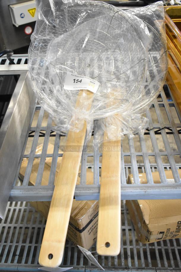 8 new scratch and dent kitchen items, including 407BSKMR12C 12" stainless skimmer with bamboo handle, wrapped in packaging.