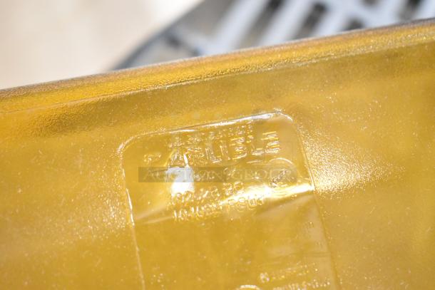 Close-up of Carlisle logo on amber high heat plastic food pan, showcasing durability and brand quality.