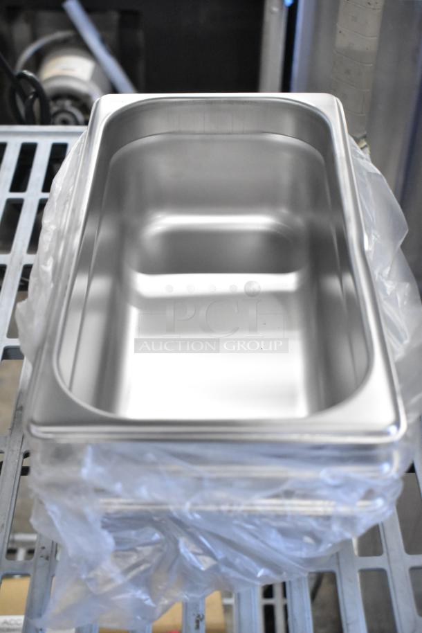 8 new stainless steel pans, anti-jam design, 4" deep, durable, ideal for steam tables or hotel use, in clear packaging.