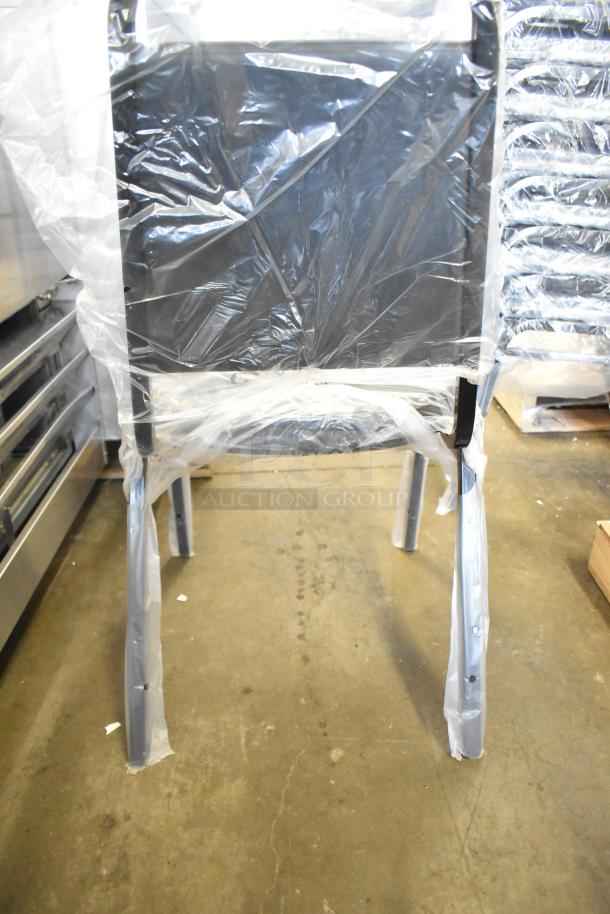14 new Lancaster black stackable chairs with 2" padded seat, wrapped in protective plastic, slight scratch and dent condition.