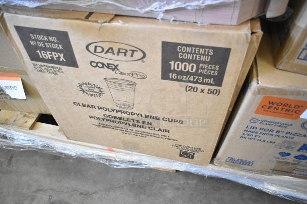 Box of Dart Conex ClearPro polypropylene cups, 1000 pieces, 16 oz/473 mL, sealed on pallet with other packaging items.