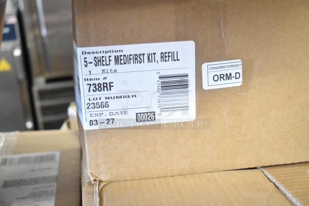 Cardboard box with label for 5-Shelf Medifirst Kit Refill. Item #738RF, Lot #23566, Exp. Date 03-27, ORM-D marked.