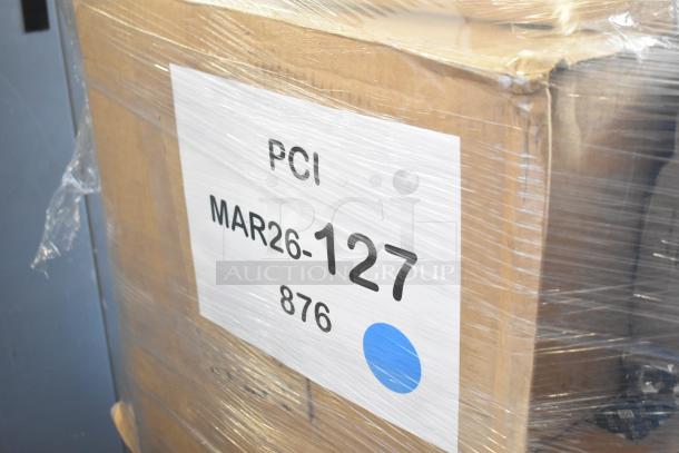 Large cardboard box wrapped in plastic; label reads "PCI MAR26-127 876" signifying auction lot for 33 scratch and dent items.