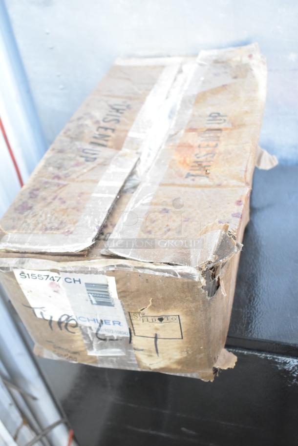 Damaged cardboard box labeled "S155747 CH" and "Kichler," indicating scratch and dent items inside. Box is taped and worn.