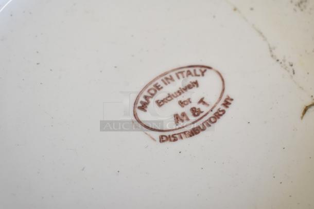 Close-up of a stamp on an item reading "Made in Italy, Exclusively for M & T Distributors NY."