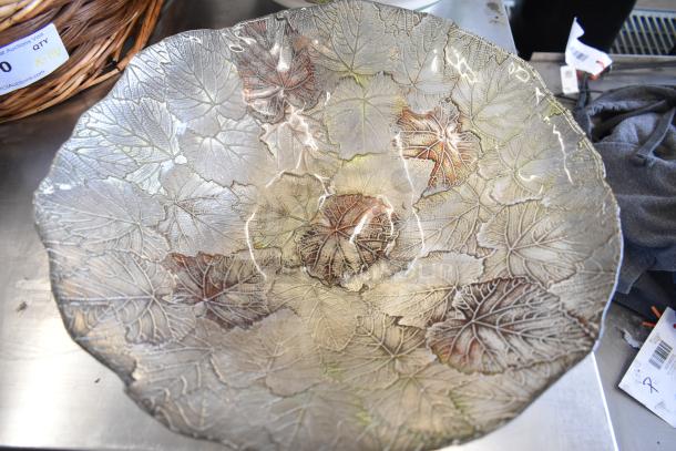 Decorative dish with embossed leaf pattern, metallic finish. Includes a wicker basket. Part of 11 assorted items auction.