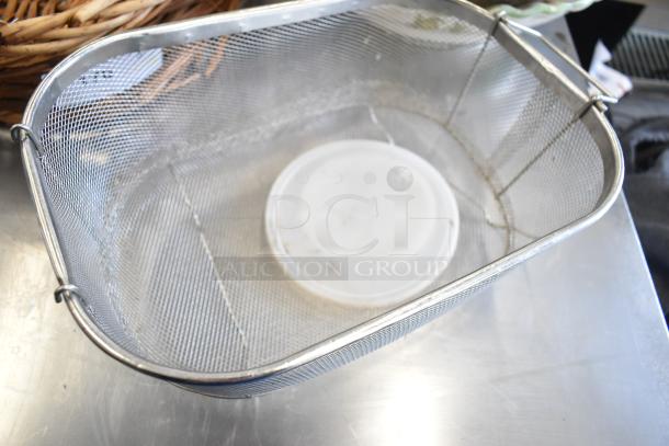 Metal wire basket with plastic base inside; part of 11-item auction lot including basket, dish, and mandolin slicer.