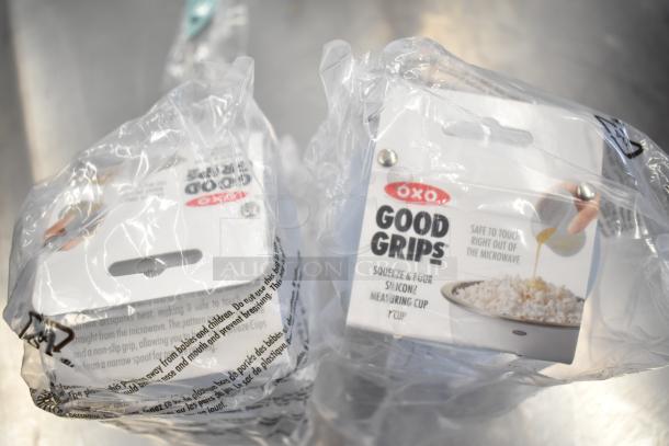 6 items, including OXO Good Grips 1 Cup Squeeze & Pour Measuring Cup. New in sealed packaging, translucent silicone design.