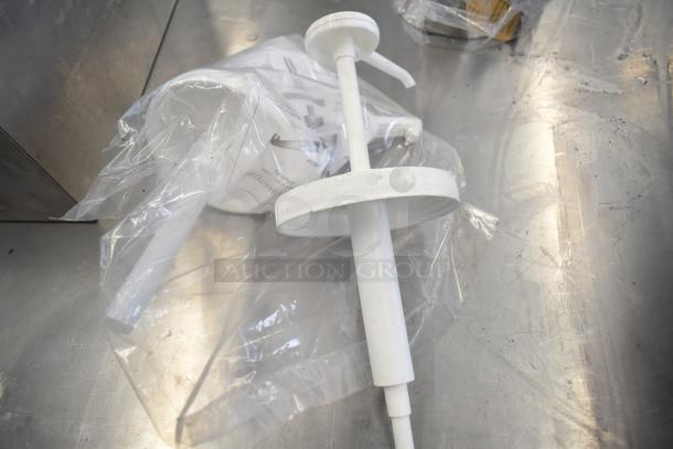 Assorted kitchen items including OXO 11161100 Good Grips silicone measuring cup, white pump top, in plastic bag.