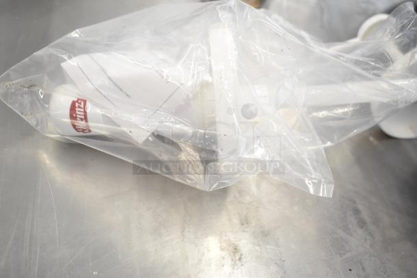 Bag containing 6 various kitchen items including an OXO silicone measuring cup and other utensils for auction, in good condition.