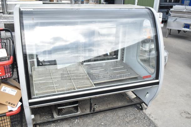 2016 Torrey TEM150+ deli display case with commercial casters, 120V, 1 phase, floor style, glass front, silver exterior.