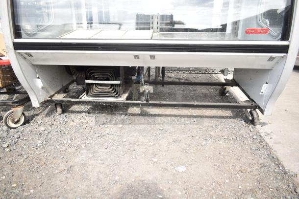 2016 Torrey TEM150+ deli display case, commercial casters, visible cooling coils, 120V, 1 phase, floor style, moderate wear.