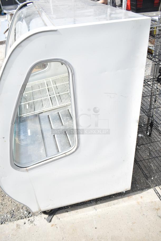 2016 Torrey TEM150+ deli display case on casters, 120V, 1 phase. Features glass front, shelving, and visible signs of wear.