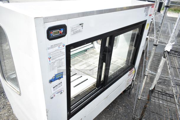 Torrey TEM150+ deli display case, commercial floor style, 2016 model, on casters. Visible control panel and info labels.