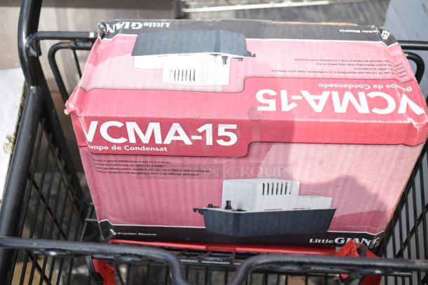 2-tier shopping cart containing a boxed Little Giant VCMA-15 condensate pump. Box shows visible wear.
