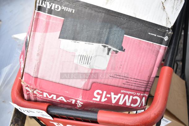 Two-tier shopping cart containing a Little Giant VCMA-15 box, visible wear on box, tagged "173 Hills OTR" on cart.