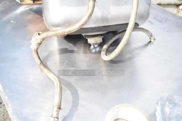 2 single bay drop-in sinks, metal finish, with attached hoses. Good condition, ideal for kitchen or utility installation.