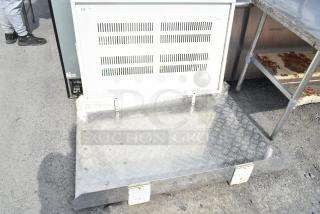 Metal panel with vent slits, checkered plating, and metal brackets. Tag reads "176 QTY 1". Used, outdoor condition.