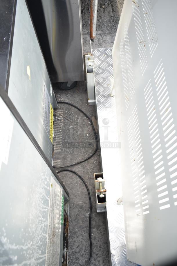 Metal panel with vents, attached to a heavy base. Visible wiring and support structure. Condition appears used with signs of wear.