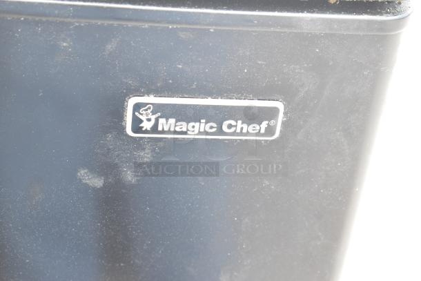 Magic Chef mini cooler, black with logo visible, part of auction for 2 coolers including Insignia model. In used condition.