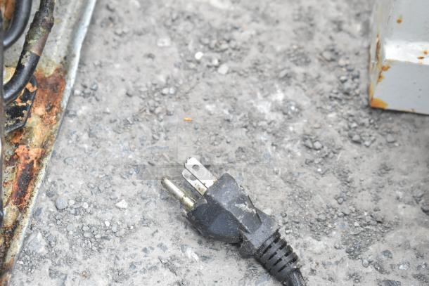 Power plug on concrete surface. No visible coolers.