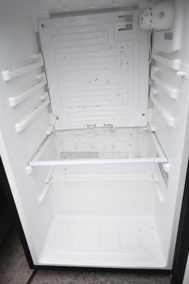 Interior of a white mini cooler with a glass shelf. Model: Magic Chef HMDR450BE or Insignia NS-CF33BK8. 115 Volts, 1 Phase.
