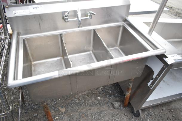 Commercial 3 bay stainless steel sink, pre-owned, with visible faucet and backsplash. Ideal for foodservice use.