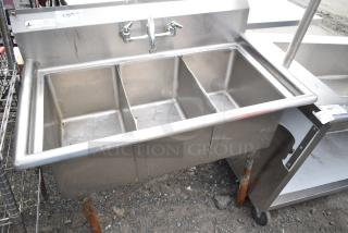 Commercial 3 bay stainless steel sink, pre-owned, with visible faucet and backsplash. Ideal for foodservice use.
