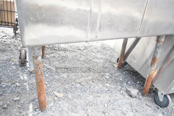Commercial 3 bay sink with stainless steel construction and visible rust on legs. Used condition, ideal for a kitchen setup.