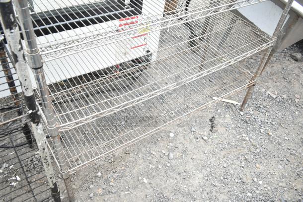 Chrome finish 6-tier wire shelving unit, used, with visible wear. Buyer must dismantle. Consider freight costs.