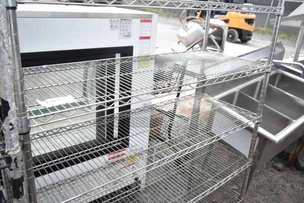 Chrome finish 6-tier wire shelving unit. Features sturdy metal construction, wire design, excellent condition. Buyer must dismantle.