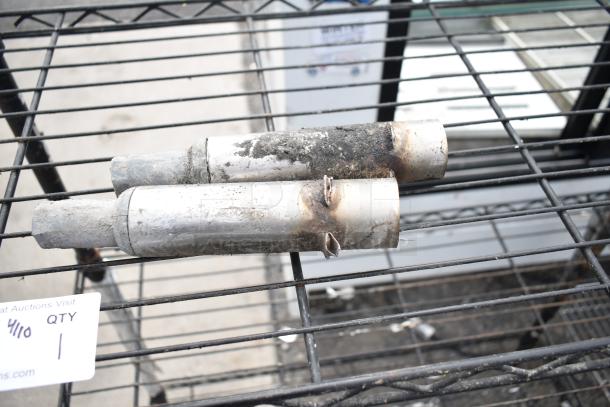 Black finish 4-tier wire shelving unit, used condition, visible wear. Buyer must dismantle for shipping. Consider freight charges.