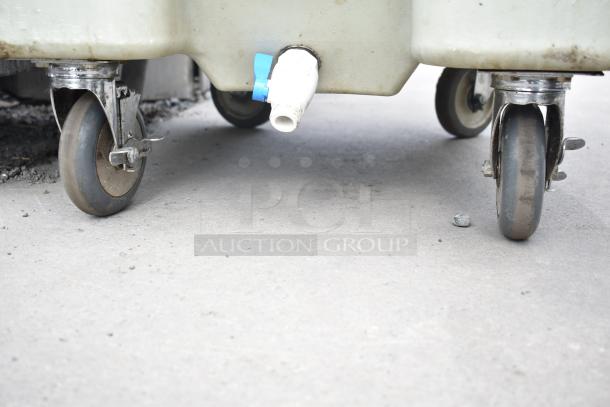 Cambro tan poly ice bin with commercial casters, showing wheels and drainage spout, used condition.